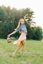 Young Caucasian woman or girl in a summer dress and a denim shirt is walking Royalty Free Stock Photo