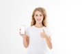 Young caucasian woman, girl in t-shirt holding blank screen mobile phone showing one or like count isolated on white background Royalty Free Stock Photo