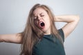 Young caucasian woman girl, yawning, tired or sleepy with messy hair Royalty Free Stock Photo