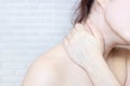 Young caucasian woman with hand on her unhealthy neck and shoulder. Self massage, office syndrome, neck ache and musclar pain Royalty Free Stock Photo