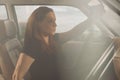 Young caucasian woman is happy driving a vintage sport car and adjusting the rear view mirror. Side view in a car, fast blurred Royalty Free Stock Photo