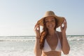 Young Caucasian woman in hat and bikini on the beach Royalty Free Stock Photo