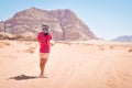 Young caucasian woman hold map disoriented lost read map alone in desert in extreme heat. Wadi rum desert hike and hiking routes Royalty Free Stock Photo