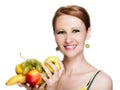 Young caucasian woman holding fruit