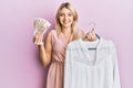 Young caucasian woman holding hanger with t shirt and russian ruble banknotes smiling with a happy and cool smile on face