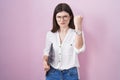 Young caucasian woman holding laptop angry and mad raising fist frustrated and furious while shouting with anger Royalty Free Stock Photo