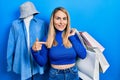 Young caucasian woman holding shopping bags pointing finger to one self smiling happy and proud Royalty Free Stock Photo