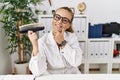 Young caucasian woman holding teeth whitening palette looking confident at the camera smiling with crossed arms and hand raised on Royalty Free Stock Photo