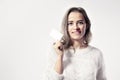 Young caucasian woman holds blank business card in hand.