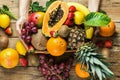 Young caucasian woman holds in hands box with raw organic tropical and seasonal summer fruits berries. Halved papaya coconut mango Royalty Free Stock Photo