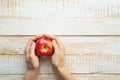 Young Caucasian Woman Holds in Hands Ripe Red Apple on White Plank Wood Background Tabletop. Flat Lay Top View Thanksgiving Royalty Free Stock Photo