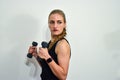 Young Caucasian woman holds a pair of dumbbells Royalty Free Stock Photo