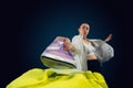 Close up of young caucasian woman ironing bright clothes with expressive emotions in action, motion