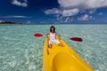 Young caucasian woman kayaking in sea at Maldives Royalty Free Stock Photo