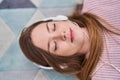 Young caucasian woman listening to music lying on floor at home Royalty Free Stock Photo