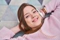 Young caucasian woman listening to music lying on floor at home Royalty Free Stock Photo