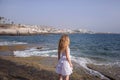 Caucasian woman looking towards the ocean, and the tourist resort known as Las Americas, Costa Adeje, Tenerife, Canary Islands Royalty Free Stock Photo