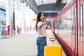 Young caucasian woman with luggage at station Royalty Free Stock Photo