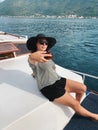 Young caucasian woman making selfie on luxury yacht with amazing beauty landscape at sunny day