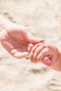 Young Caucasian Woman Mother Holds Hand of Little Baby Toddler. Bright Sunny Summer Day. Beach Sand Seashore. Family Vacation Royalty Free Stock Photo