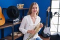 Young caucasian woman musician smiling confident holding trumpet at music studio Royalty Free Stock Photo