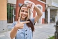 Young caucasian woman outdoors smiling making frame with hands and fingers with happy face Royalty Free Stock Photo