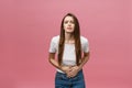 Young caucasian woman over isolated background with hand on stomach because indigestion, painful illness feeling unwell Royalty Free Stock Photo