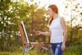 Young caucasian woman painting outdoors Royalty Free Stock Photo