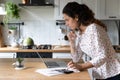 Young Caucasian woman pay bills on laptop online Royalty Free Stock Photo