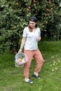 Young caucasian woman picking apples in the garden Royalty Free Stock Photo