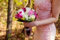 Young caucasian woman in pink lace dress holds a bouquet Royalty Free Stock Photo