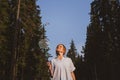 Young Caucasian woman plays badminton on a background of blue sky and forest. Royalty Free Stock Photo