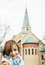 Young caucasian woman posing with parish church of saint Stephen Royalty Free Stock Photo