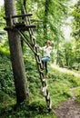 Young caucasian woman posing on the wooden ladder, natural scene Royalty Free Stock Photo