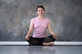 Young caucasian woman practicing yoga, doing Sukhasana exercise, Easy Seat pose Royalty Free Stock Photo