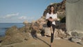 Young caucasian woman practising yoga on the rocky sea coast Royalty Free Stock Photo