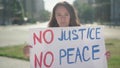 Young Caucasian woman protesting against discrimination and prejudice. Portrait of serious beautiful demonstrator with