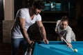 Young Caucasian Woman Receiving Advice from a man On Shooting Pool Ball While Playing Billiards Royalty Free Stock Photo