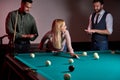 young caucasian woman receiving advice on shooting pool ball while playing billiards with friends Royalty Free Stock Photo