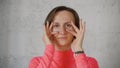 Young caucasian woman in red rose turtleneck make faces infront of camera close up