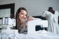 Young caucasian woman sews at home