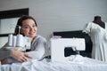 Young caucasian woman sews at home