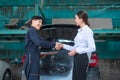 Young Caucasian woman shaking hand with mechanic man feeling happy about repair service Royalty Free Stock Photo