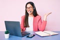 Young caucasian woman sitting at the desk wearing call center agent headset working using laptop celebrating victory with happy Royalty Free Stock Photo