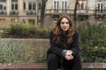 Young Caucasian Woman Sitting on Park Bench Backrest