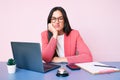 Young caucasian woman sitting at the recepcionist desk working using laptop thinking looking tired and bored with depression