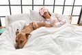 Young caucasian woman sleeping lying on bed with dog at bedroom Royalty Free Stock Photo