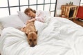 Young caucasian woman sleeping lying on bed with dog at bedroom Royalty Free Stock Photo