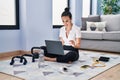 Young caucasian woman sporty using laptop sitting on floor at home Royalty Free Stock Photo