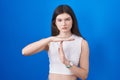 Young caucasian woman standing over blue background doing time out gesture with hands, frustrated and serious face Royalty Free Stock Photo